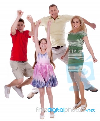 Cheerful Family Jumping To The Air And Having Fun Stock Photo