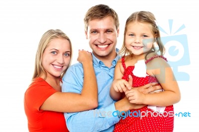 Cheerful Family Of Three Facing Camera And Smiling Stock Photo