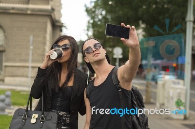 Cheerful Friends Taking Photos Of Themselves On Smart Phone Stock Photo