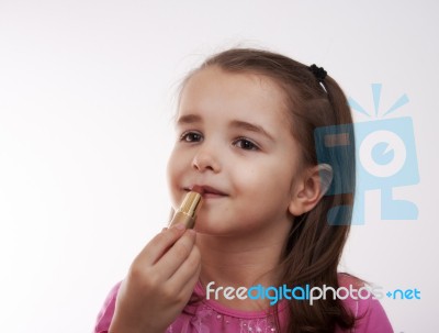 Cheerful Girl Paints Lips Stock Photo