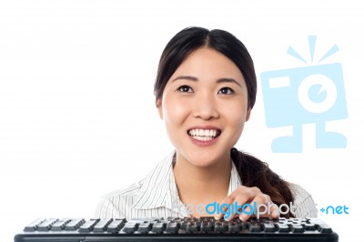 Cheerful Girl Using Computer Keyboard To Type Stock Photo