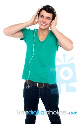 Cheerful Guy Enjoying Music Stock Photo