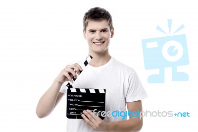 Cheerful Guy Holding Clapperboard Stock Photo