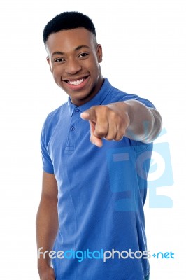 Cheerful Guy Pointing Towards Camera Stock Photo