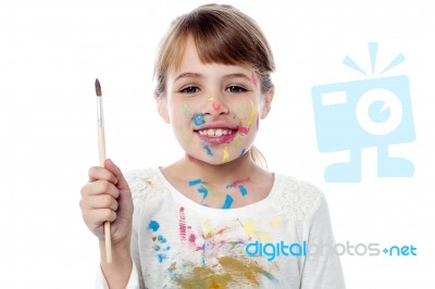 Cheerful Kid Holding A Paint Brush Stock Photo