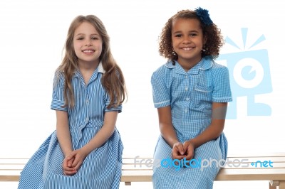 Cheerful Kids Relaxing On School Bench Stock Photo