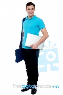 Cheerful Man Carrying Laptop, Off To Work Stock Photo