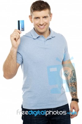 Cheerful Man Holding Credit Card Stock Photo