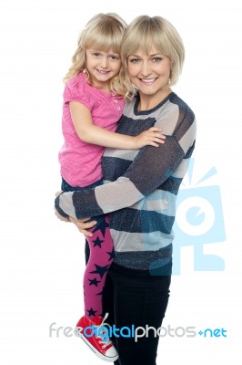 Cheerful Mother Carrying Her Cute Daughter Stock Photo