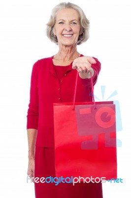 Cheerful Old Woman Holding Shopping Bag Stock Photo