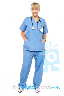 Cheerful Relaxed Female Doctor In Uniform Stock Photo