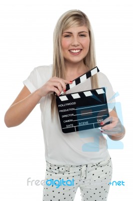 Cheerful Teen Girl With Clapboard In Hand Stock Photo