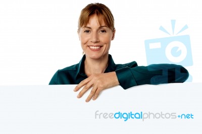 Cheerful Woman Holding Blank Ad Board Stock Photo