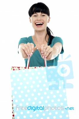 Cheerful Woman Holding Polka Dot Shopping Bags Stock Photo