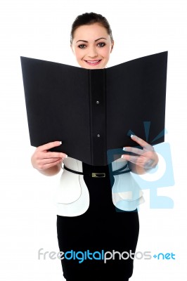 Cheerful Woman Looking At The File In Hands Stock Photo