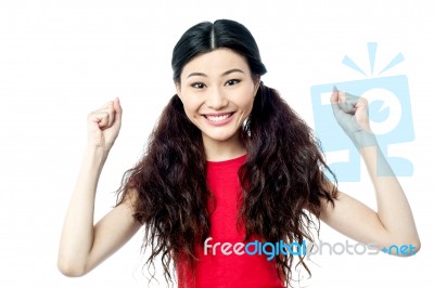 Cheerful Woman With Clenched Fists Stock Photo