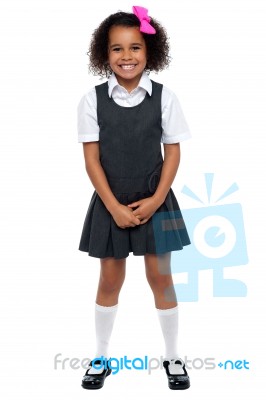 Cheerful Young Kid In Pinafore Dress Posing Smilingly Stock Photo