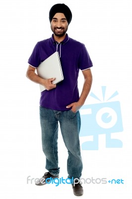 Cheerful Young Man Holding Laptop Stock Photo