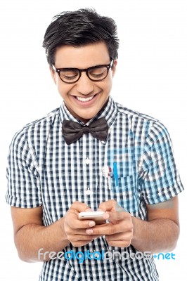 Cheerful Young Man Using Mobile Phone Stock Photo