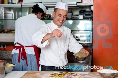 Chef Busy In Process Of Preparing Pizza Stock Photo