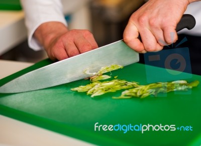 Chef Chopping Leek And Doing Preparations Stock Photo