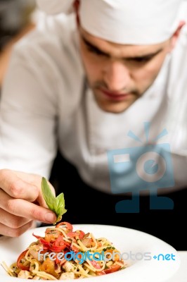 Chef Garnishing Pasta Stock Photo