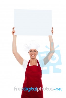 Chef Holding Board Over Her Head Stock Photo