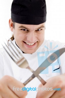 Chef Holding Fork And Knife Stock Photo