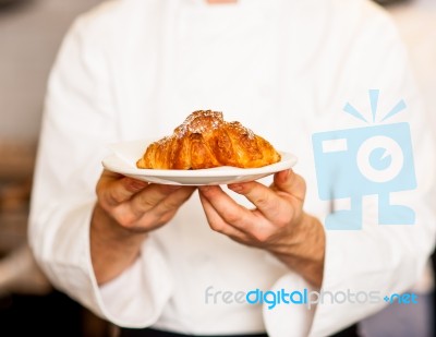 Chef Holding Fresh And Tasty Roll Croissants Stock Photo