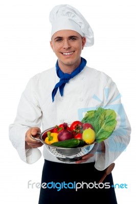 Chef Holding Fresh Vegetables In Strainer Bowl Stock Photo