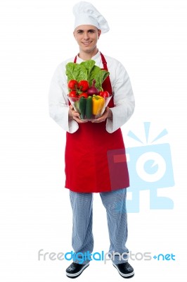 Chef Holding Glass Bowl Full Of Vegetables Stock Photo