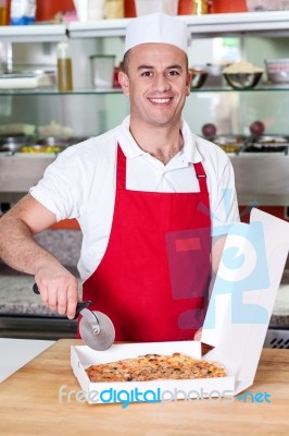 Chef Holding Pizza Cuter, Ready To Cut Stock Photo