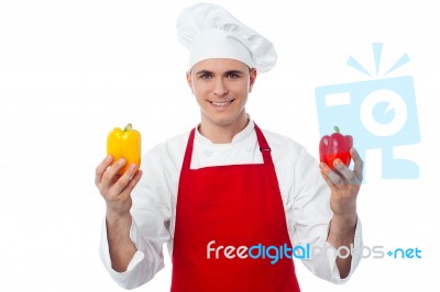 Chef In Uniform Showing Capsicums Stock Photo