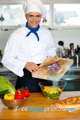 Chef Putting Vegetables In A Bowl Stock Photo