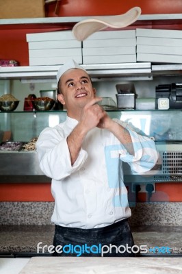 Chef Throwing The Pizza Base Dough Stock Photo