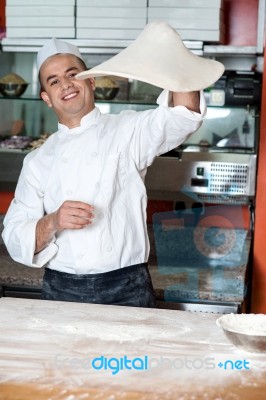 Chef Throwing The Pizza Base Dough Stock Photo