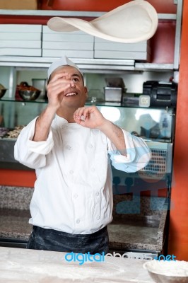 Chef Throwing The Pizza Base Dough Stock Photo