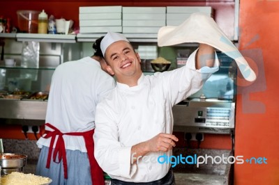 Chef Throwing The Pizza Base Dough Stock Photo