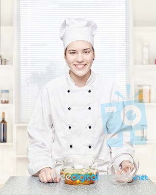 Chef With A Soup In A Glass Pot Stock Photo