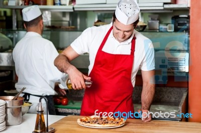 Chefs At Work Inside Restaurant Kitchen Stock Photo