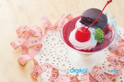 Cherry Cheesecake With Macaron And Measurements Tape Stock Photo