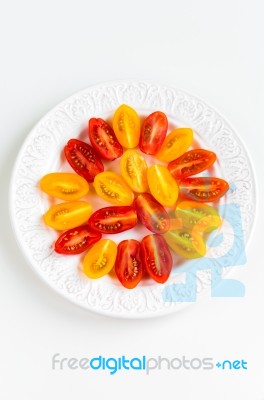 Cherry Tomatoes On White Plate Stock Photo