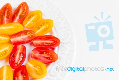 Cherry Tomatoes On White Plate Stock Photo