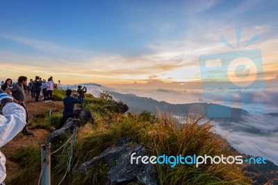 Chiang Rai, Thailand-oct. 25 2016:  Group Of Tourist Taking Photos And Waiting For The Sunrise Over The Cloud Scape On Peak Mountains In Winter At Phu Chi Fa Forest Park, Chiang Rai Province In Thailand Stock Photo