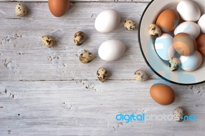 Chicken And Quail Eggs On The White Wooden Table Stock Photo