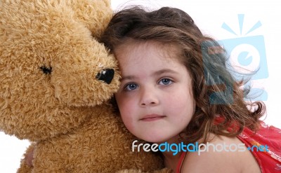 Child Hugging Teddy Bear Stock Photo