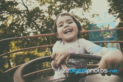 Child In Ferris Wheel Stock Photo