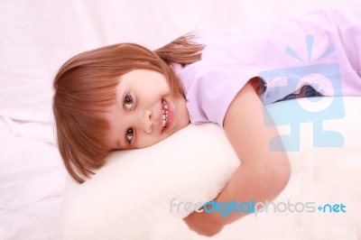 Child Lying On Bed Stock Photo