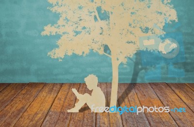 Child Studying Under Tree Stock Photo