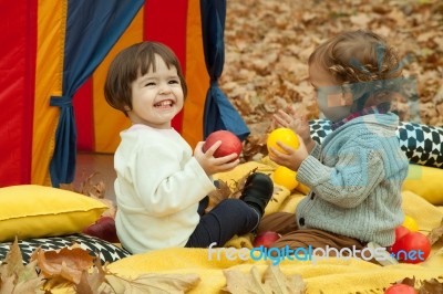 Children Play In The Park And Eating Apple Stock Photo